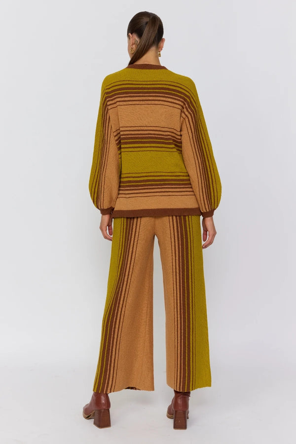 Person wearing a brown and green striped outfit on a white background