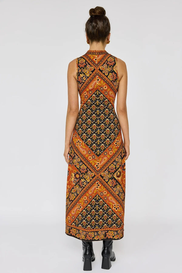 Woman wearing a patterned dress on a white background