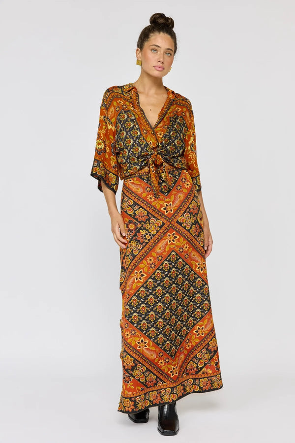 Woman wearing a patterned dress on a white background