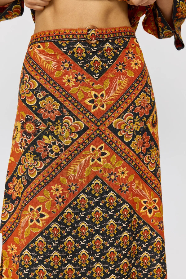 Colorful patterned skirt with orange, black, and yellow design on a white background