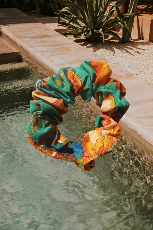 Colorful scrunchie hanging over a pool