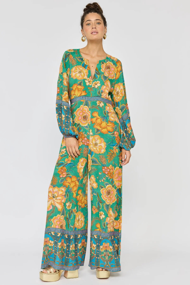 Woman wearing a floral jumpsuit on a white background