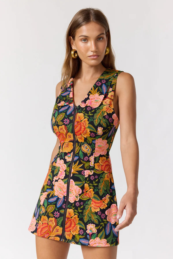 Woman wearing a colorful floral dress on a white background